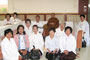 Venerable Phrakhru Sitthiwarakhom poses with Buddhist pilgrims in a local hotel, Bodh Gaya