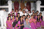 Venerable Phrakhru Sitthiwarakhom poses with local people after walk with lighted candles in hand around a temple.